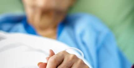 Elder patient holding hands