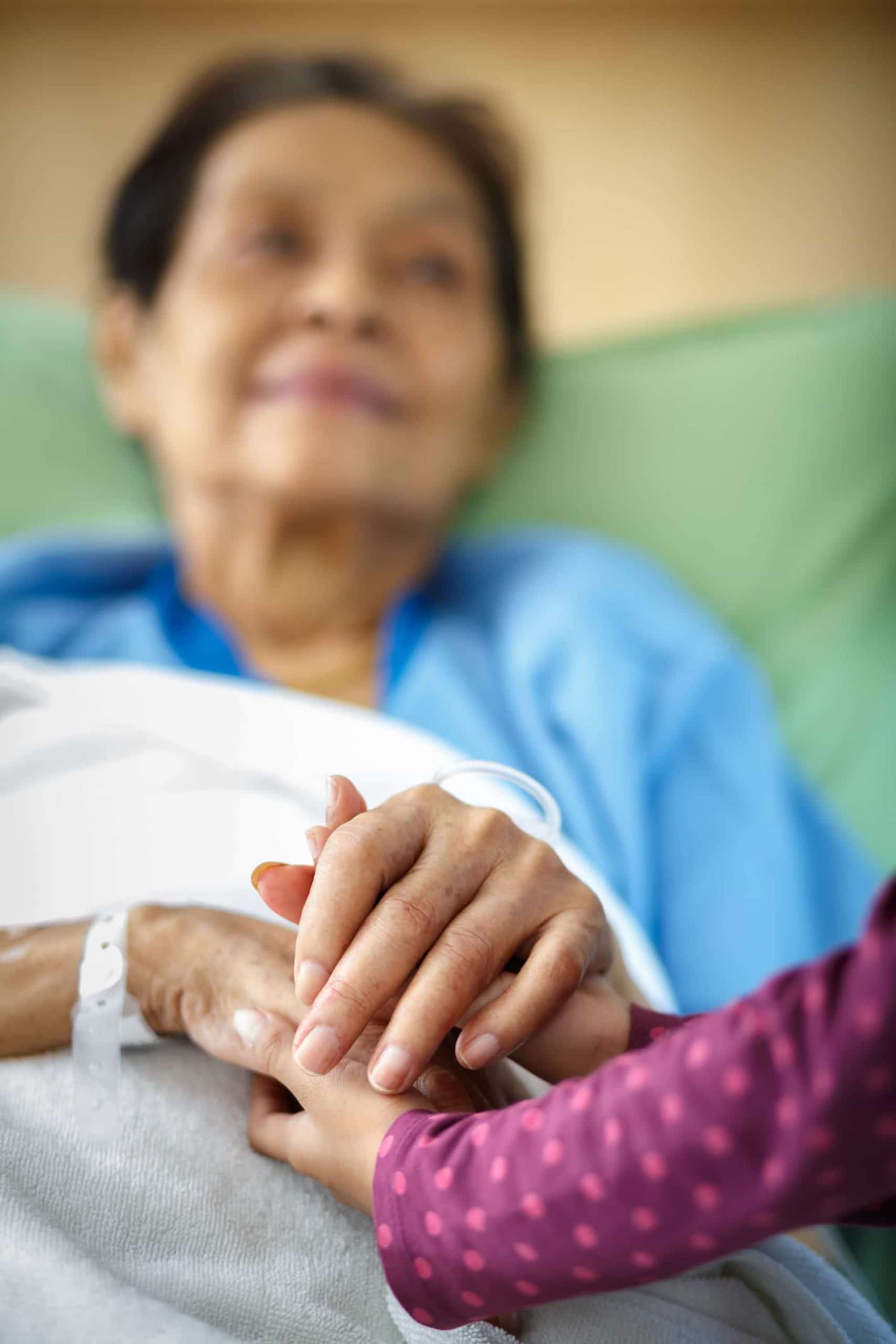 Elder patient holding hands