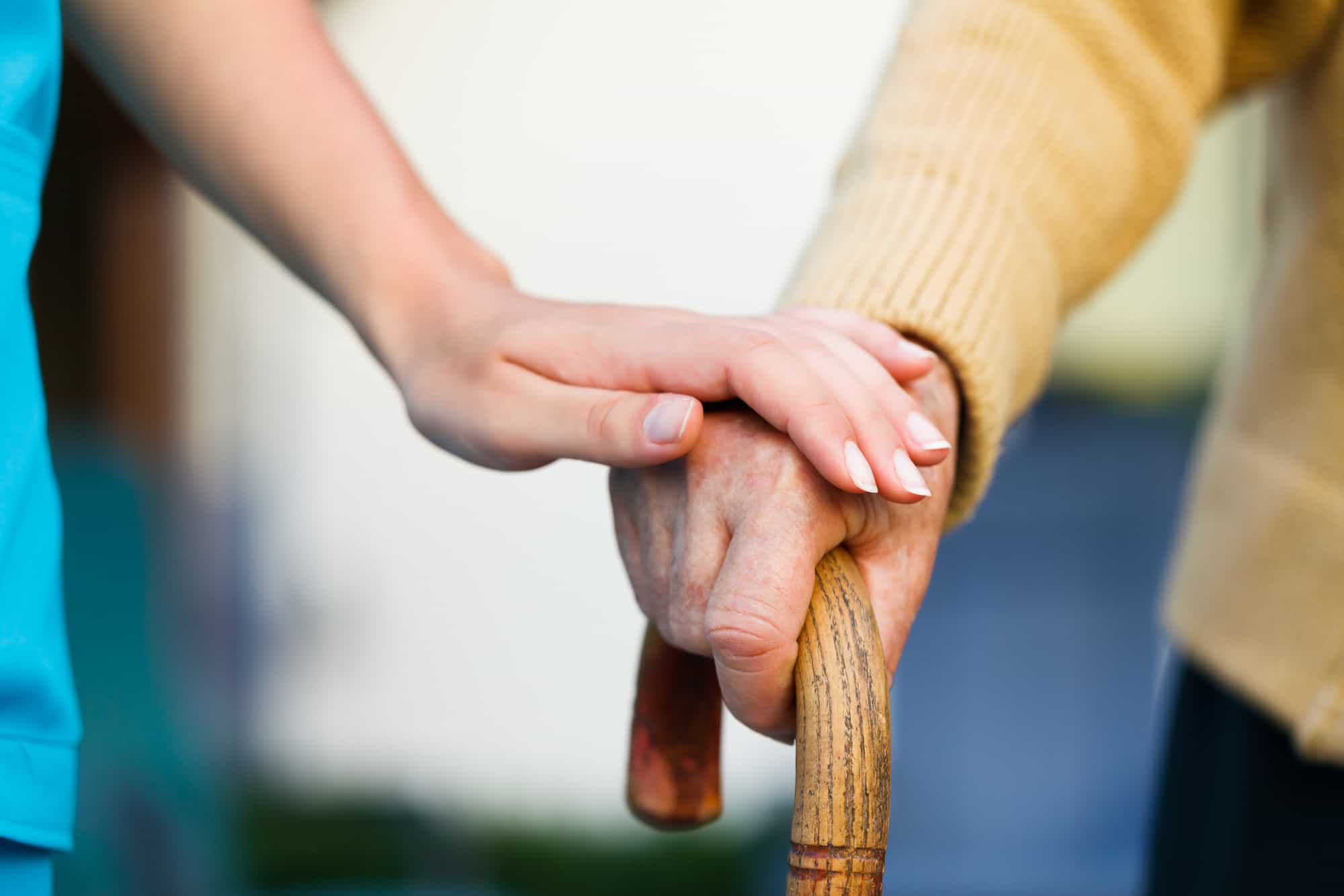 Doctor holding a senior patients hand