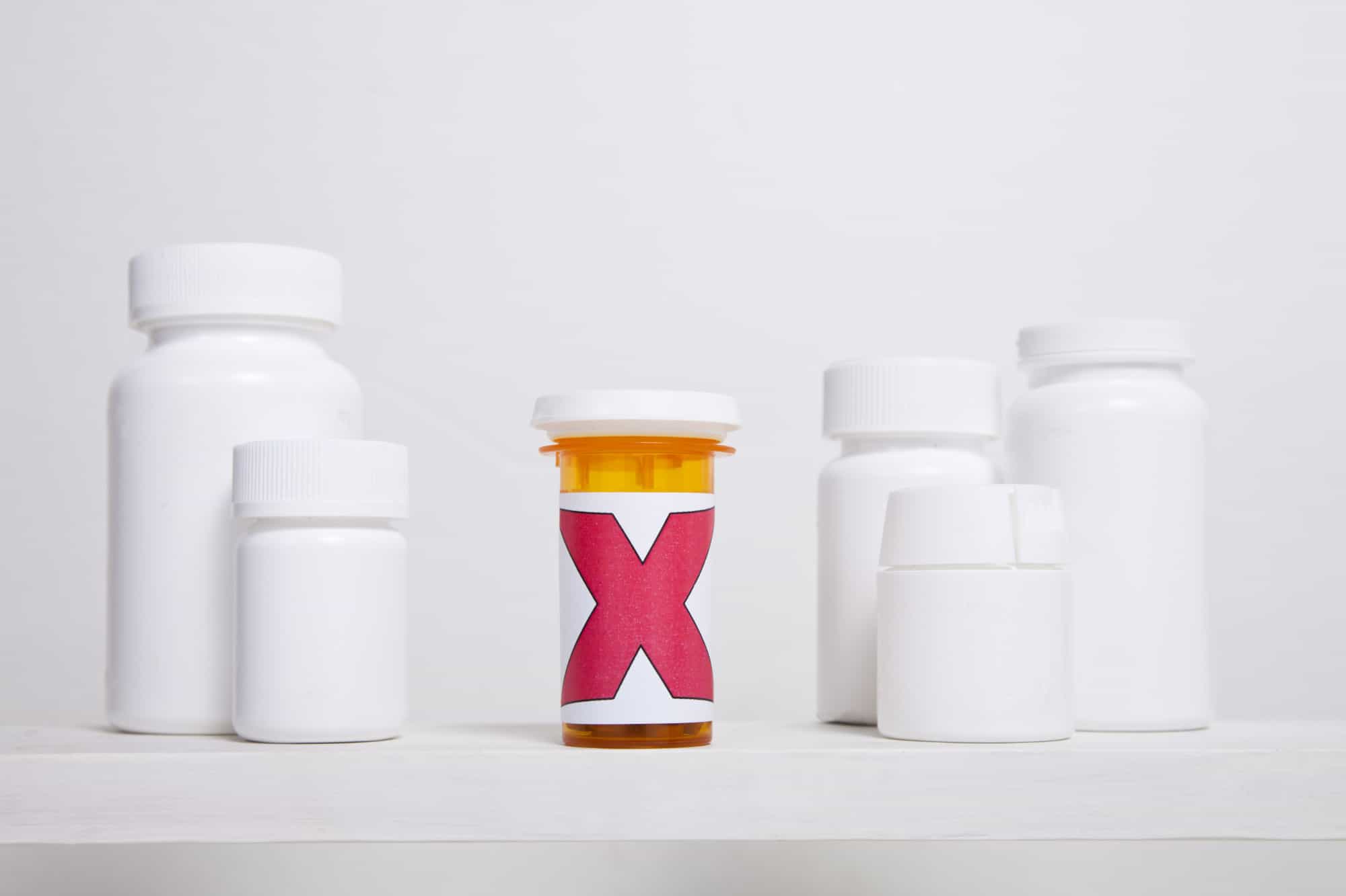 Pill bottle with X