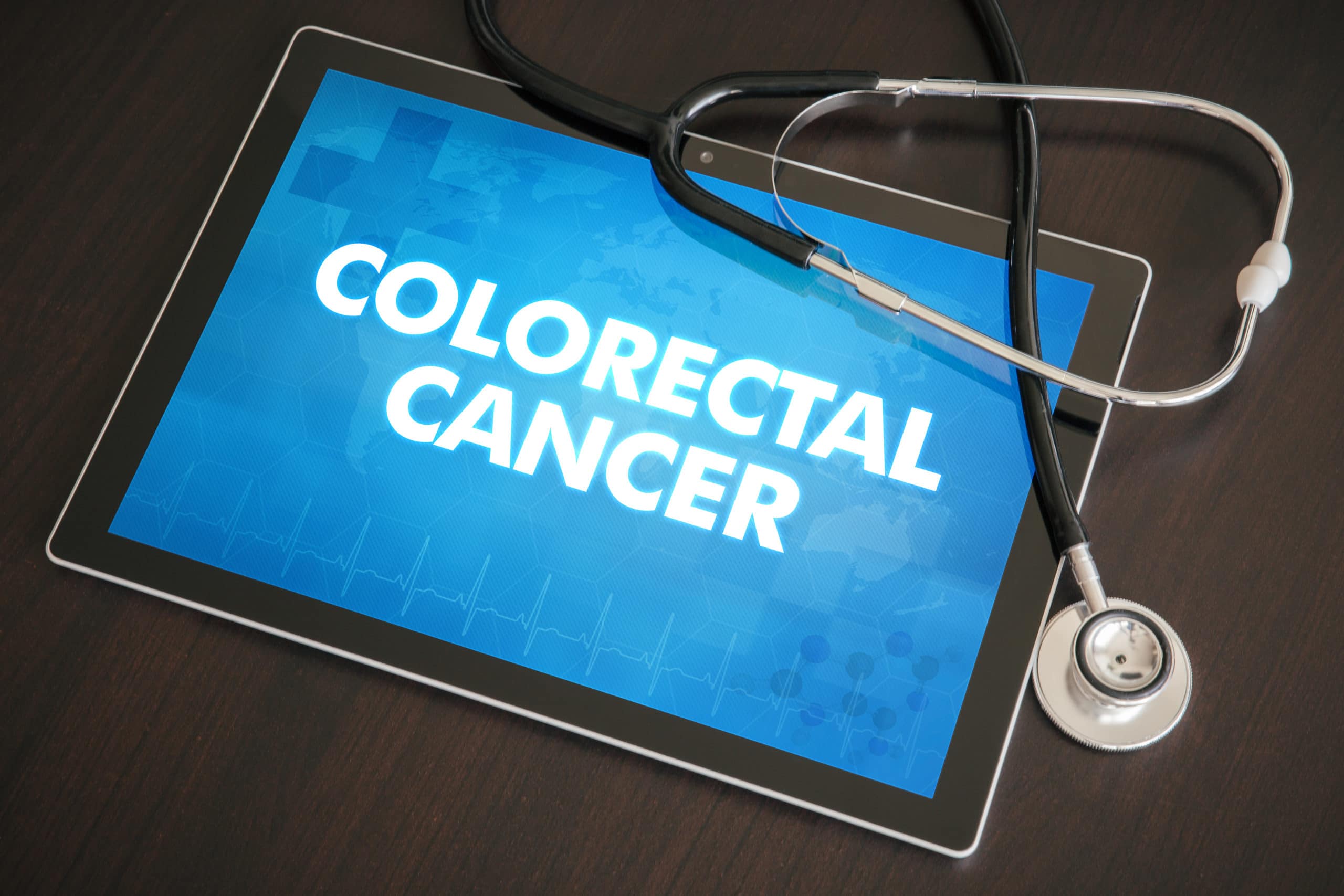 Colorectal cancer (gastrointestinal disease) diagnosis medical concept on tablet screen with stethoscope.