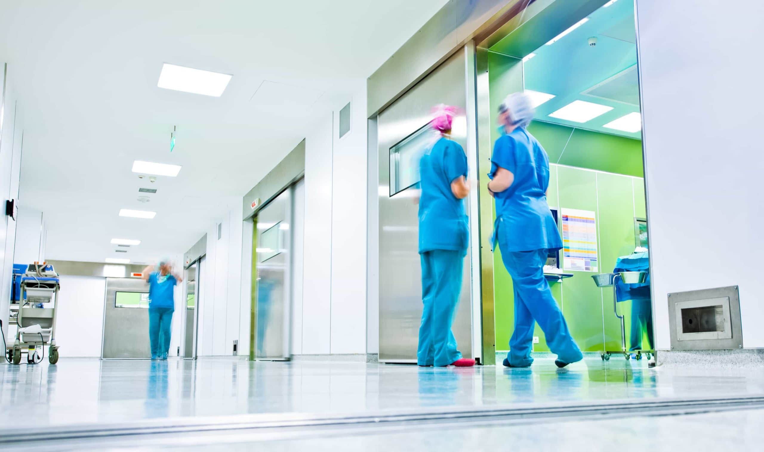 Blurred figures in medical uniforms