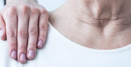 Close-up of young elegant woman's hand on senior lady's shoulder