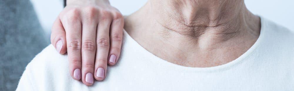 Close-up of young elegant woman's hand on senior lady's shoulder