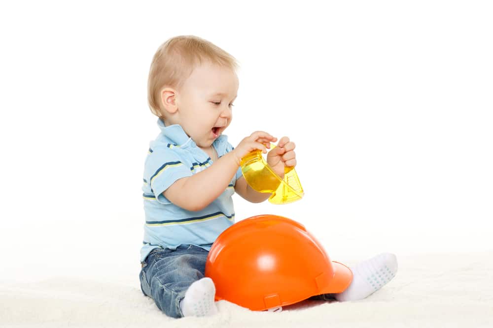 baby playing with a hard hat